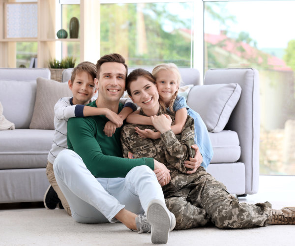 Family of four sitting together smiling