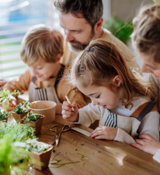 happy family planting herbs together at spring