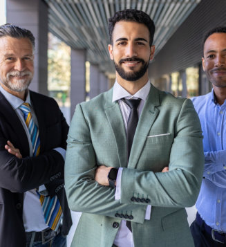 Corporate team of male colleagues looking at camera